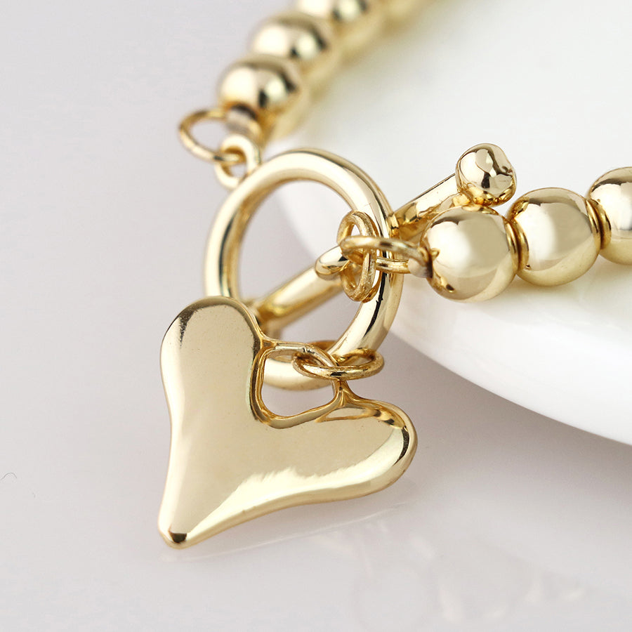 Golden bead and heart charm tbar bracelet