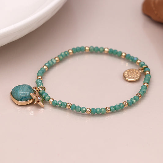 Sea green and golden charm bracelet with star and stone