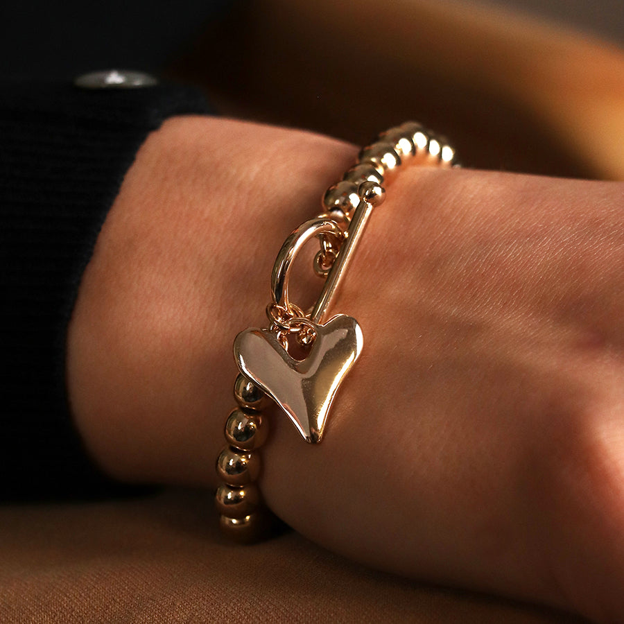 Golden bead and heart charm tbar bracelet