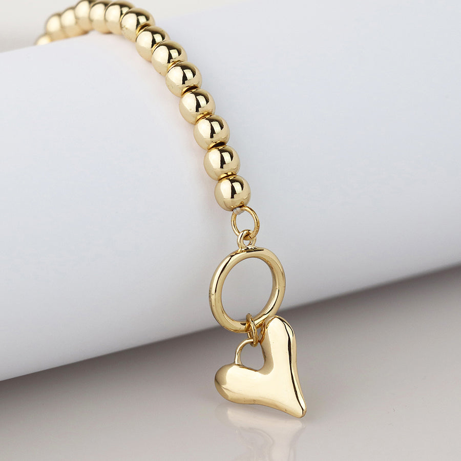 Golden bead and heart charm tbar bracelet
