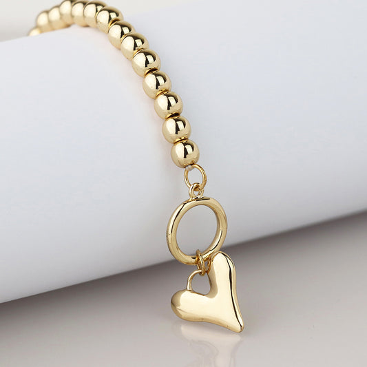 Golden bead and heart charm tbar bracelet